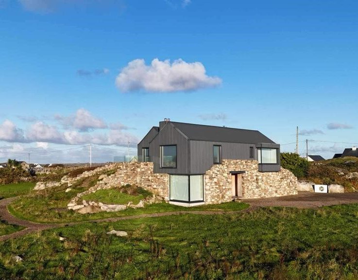 Side elevation of repurposed cottage in Connemara showing how the home comes out of the rock