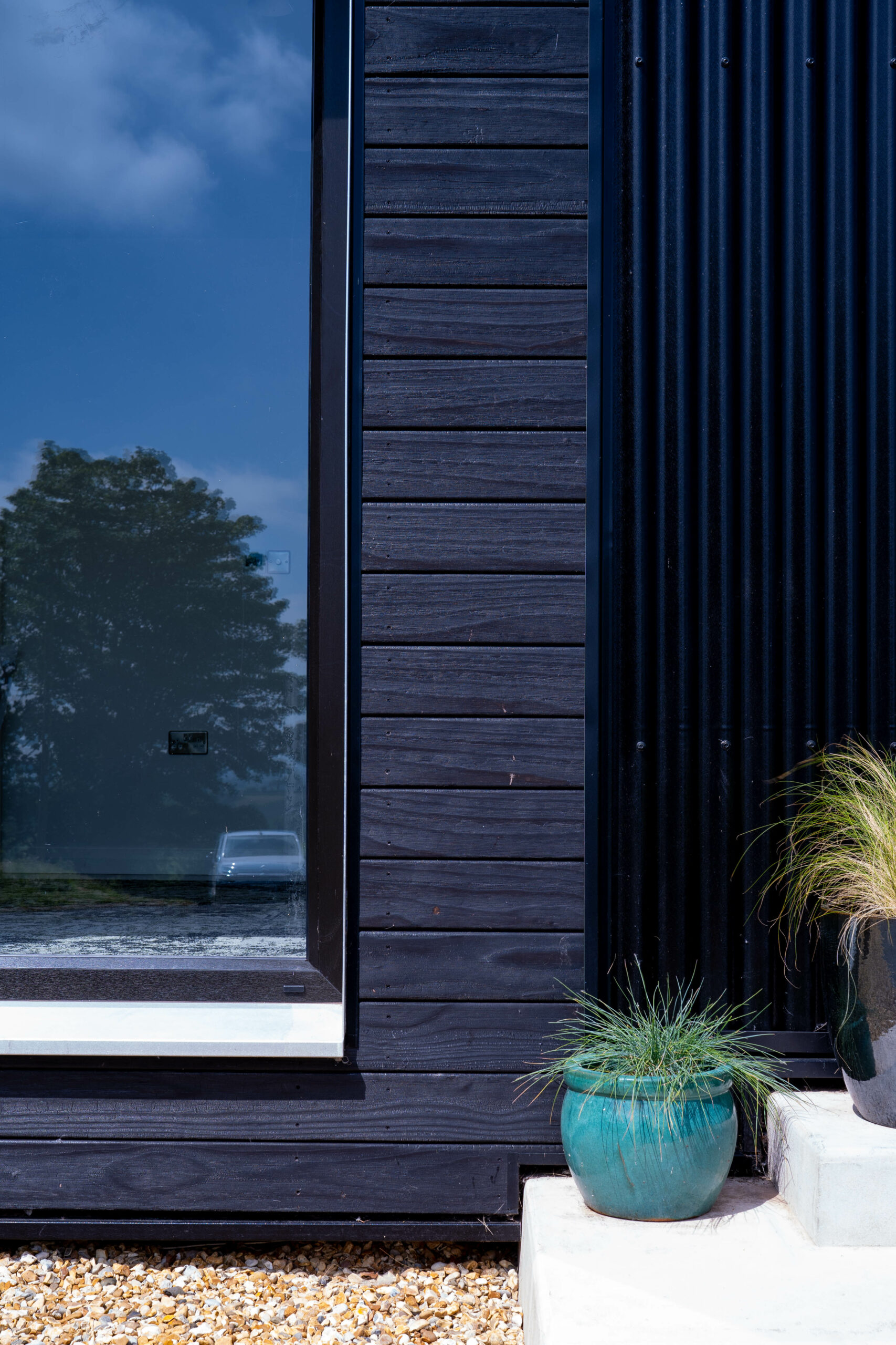 Tall windows set in the black metal cladding