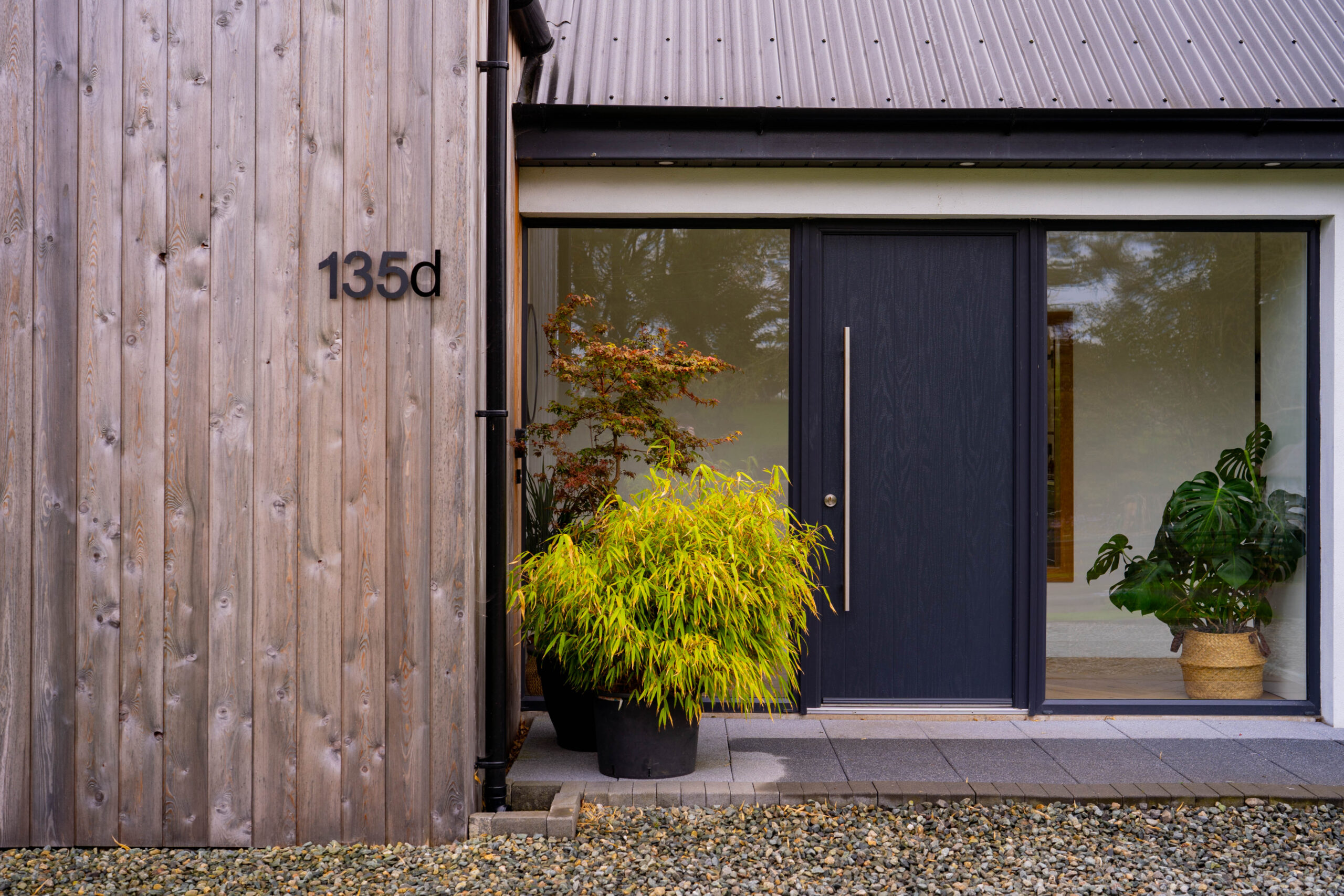 Close up of front door and wooden cladding