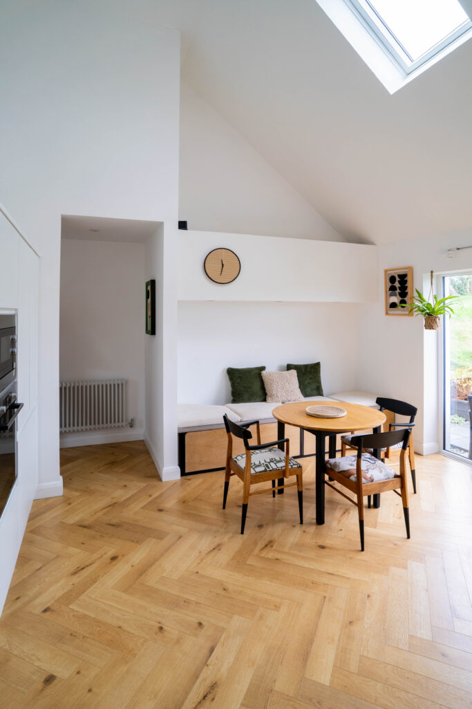 Interior shot of open plan kitchen and dining area with vaulted ceiling