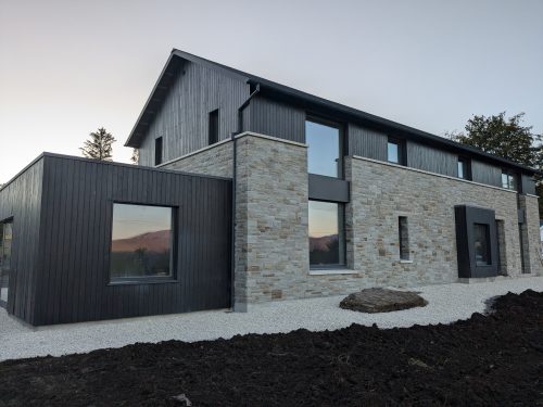 New build Co. Donegal. Clad in stained larch and sandstone