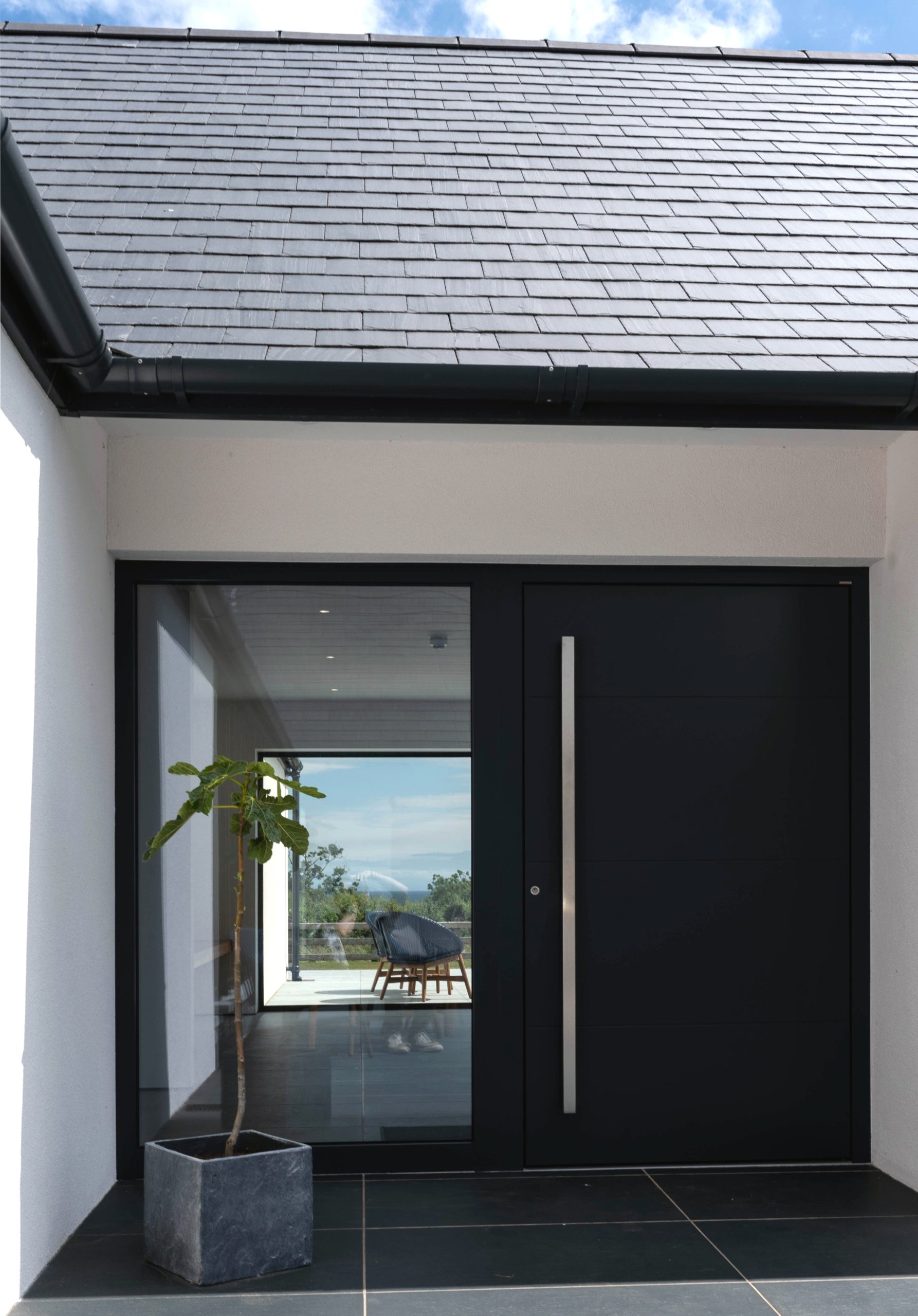 Black front door on white render Carnlough